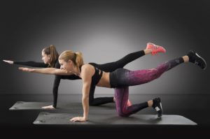 Mother and Daughter Working Out Using a Home Fitness Program